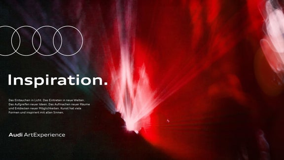 Abstrakte Lichtinstallation mit roten und weißen Strahlen auf dunklem Hintergrund, Schriftzug „Inspiration“.