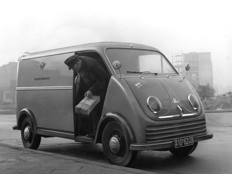 Black and white photo of a postman in a DKW F 89 L express lorry with a Deutsche Bundespost logo on the side