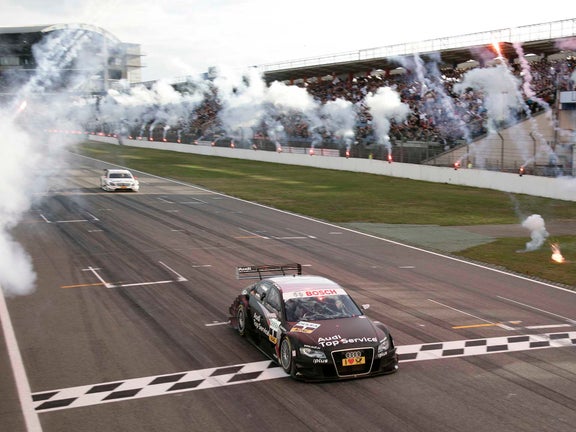A picture of Timo Scheider’s Audi A4 DTM crossing the finish line at Hockenheim in 2009.