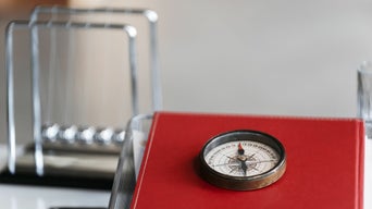 A compass lies on a red book