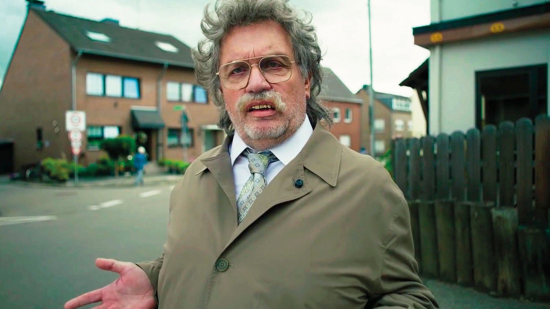 Hape Kerkeling als Horst Schlämmer steht an einer Straßenecke in Grevenbroich.