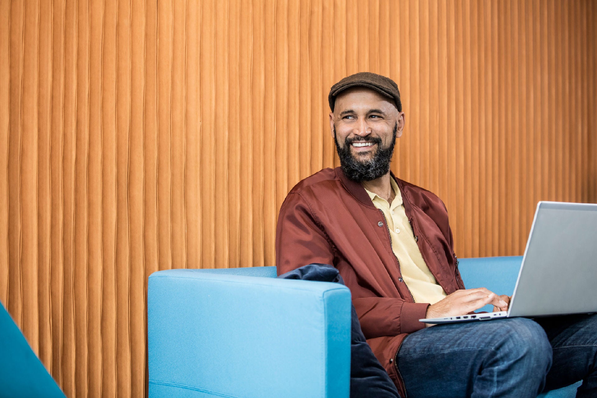 SAP specialist sitting at a couch with laptop