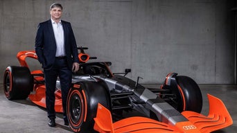 Bild på Jürgen Rittersberger bredvid en F1 bil.