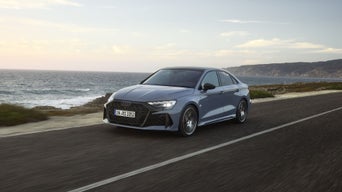 An RS 3 Sedan driving down a coastal road