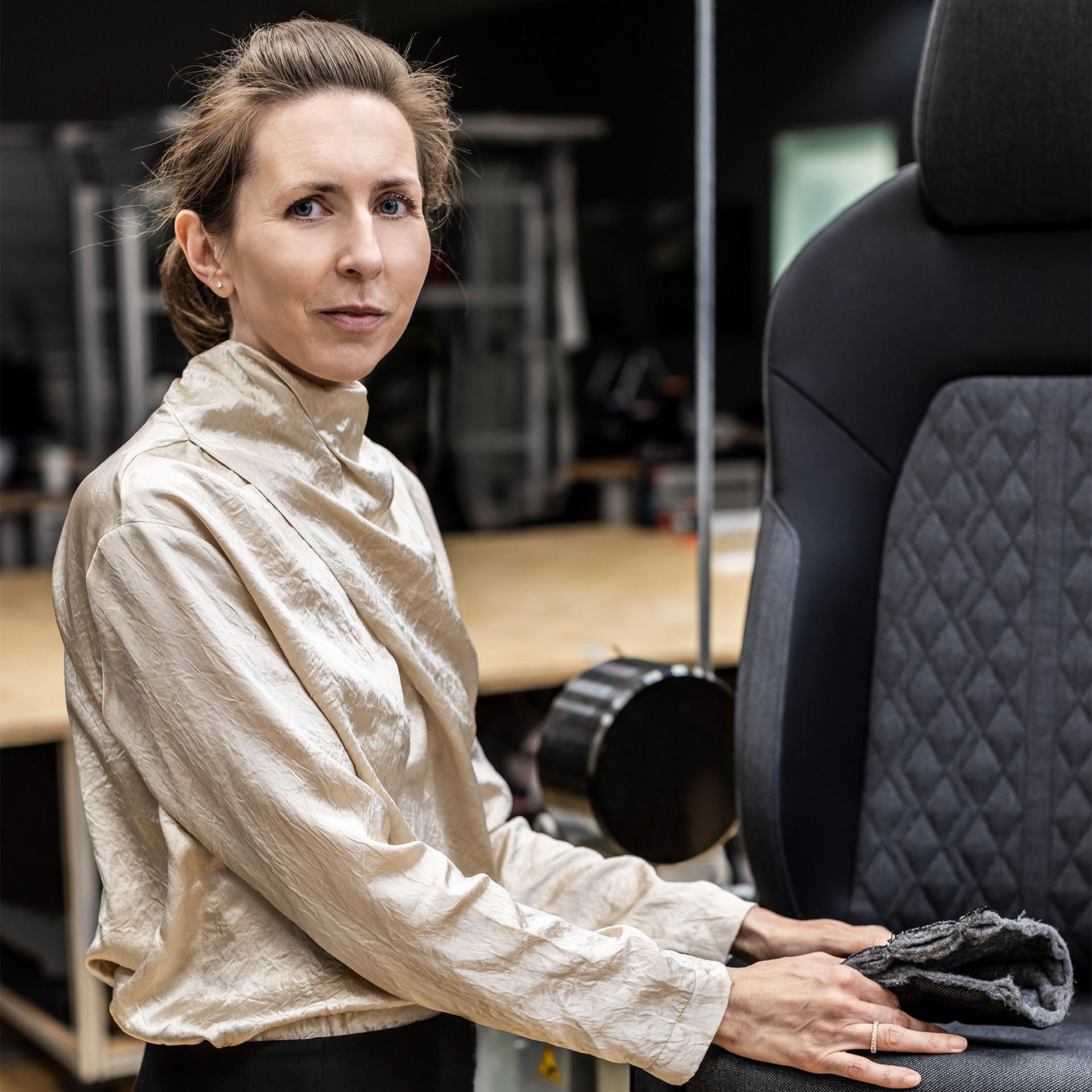 Christine Maier next to a car seat