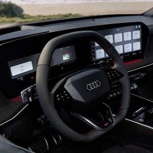 View of the cockpit with focus on the steering wheel with gear selector.