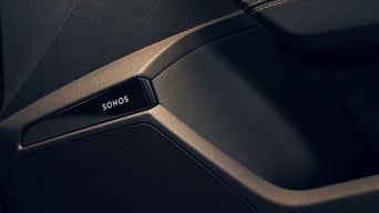 Close-up of a black Sonos speaker detail in a car door