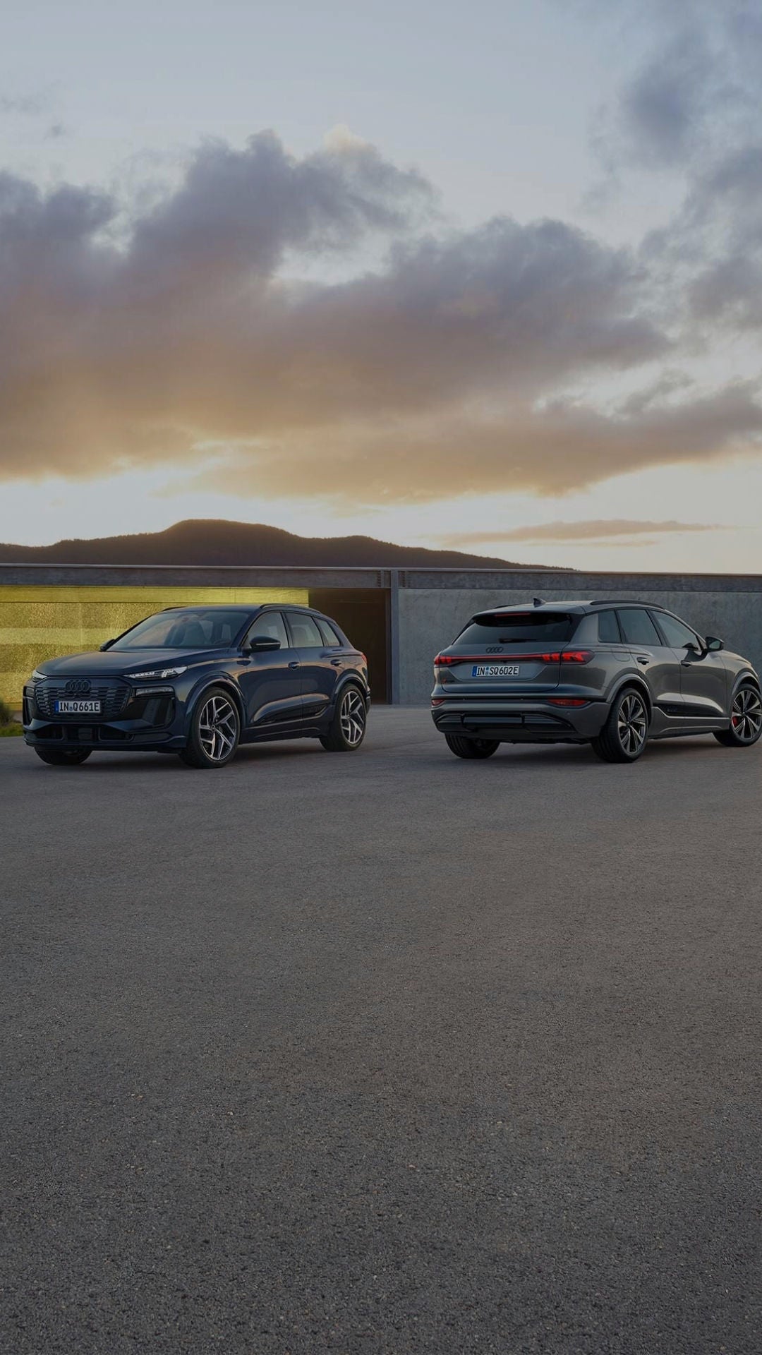 Two Audi electric vehicles parked side to side facing away from each other