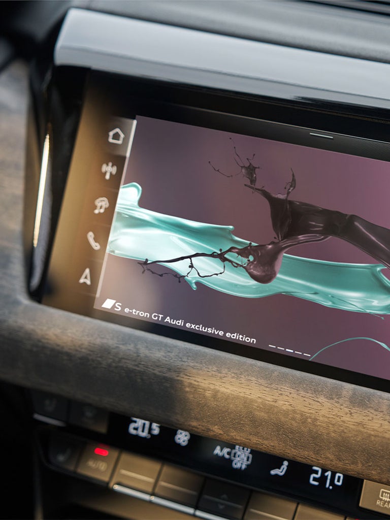 Infotainment-Display im Audi S e-tron GT zeigt ein Design mit türkisfarbenen und schwarzen Farbeffekten.