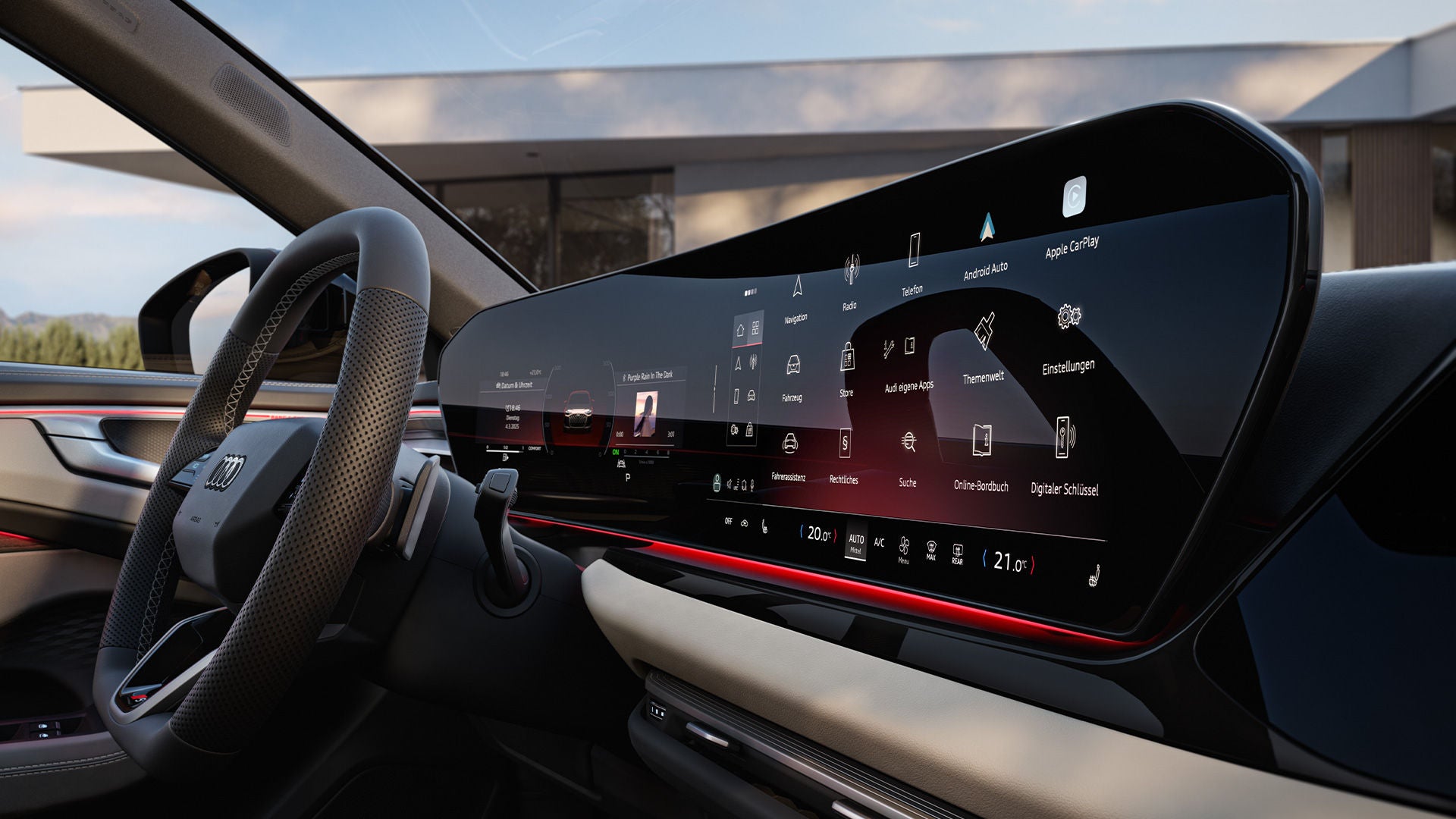 Modernes Audi-Cockpit mit breitem Touchdisplay zeigt Menü mit Apps, Navigation, Medien und Fahrzeugeinstellungen bei Tageslicht.