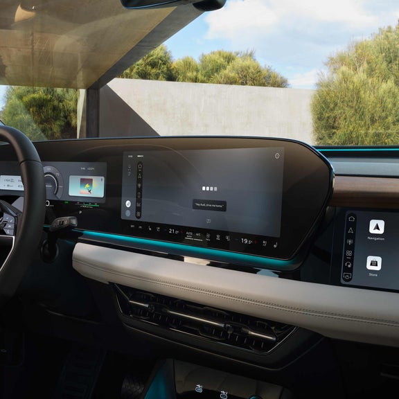 Close-up of the MMI touch display showing the Audi assistant interface.