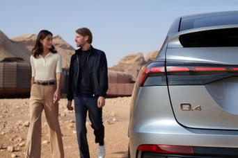Couple standing next to their Audi Q4 e-tron