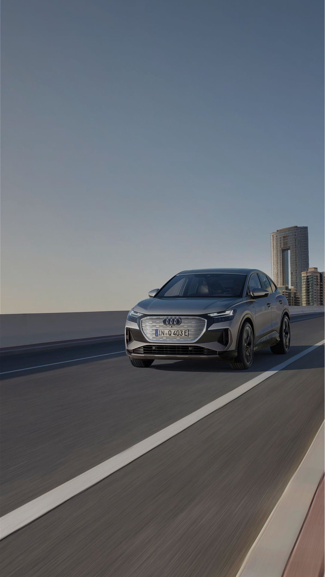 An Audi Q4 in motion on a city road