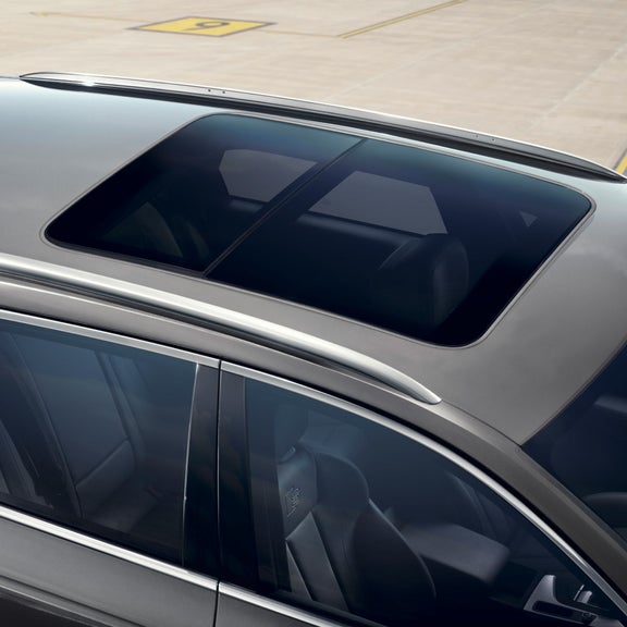 Close-up view of a car's panoramic sunroof on a grey vehicle.