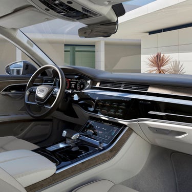 Interior view of a car with a dashboard and touchscreen controls.