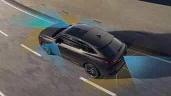 Matte black Audi Q3 on the road with visual overlays showing areas monitored by its advanced driver assistance sensors.