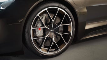 An Audi specialist with a young family who is handing an Audi key fob to them