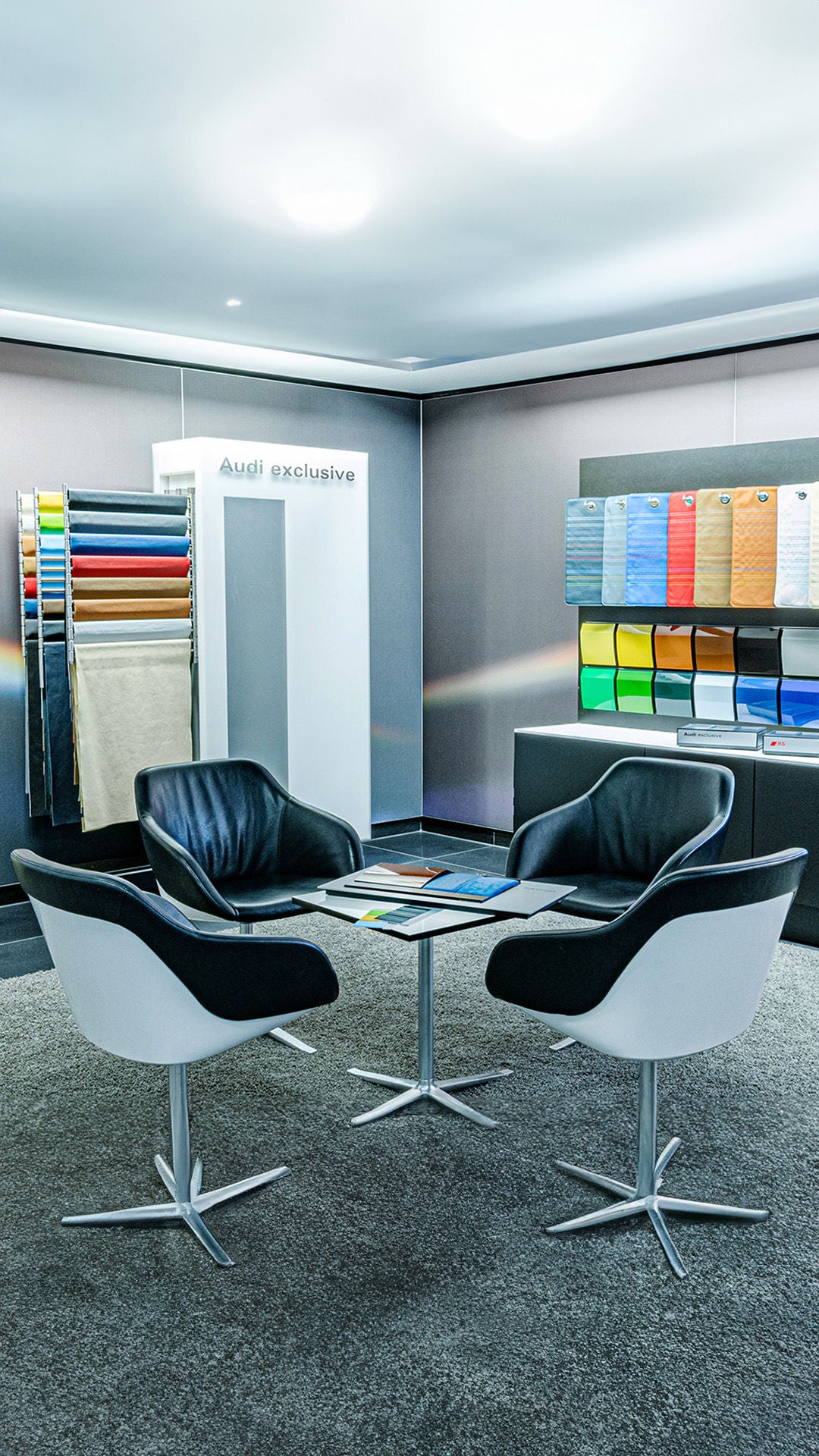 Presentation room with fabric and paint samples and leather chairs.