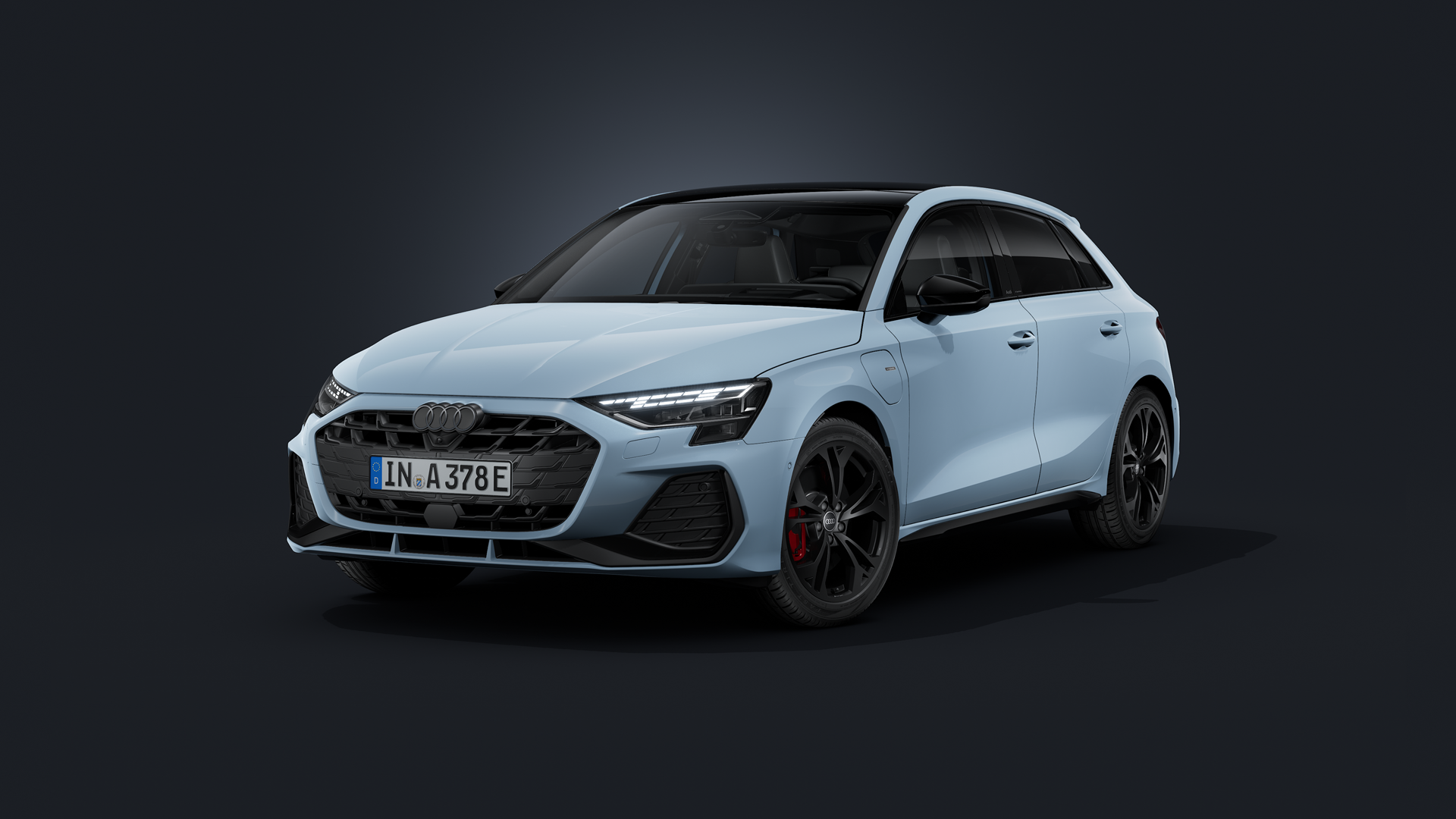 The Audi A3 Sportback e-hybrid with Audi exclusive custom paint in “Kumulusbau,” viewed from the front at an angle against a dark background.