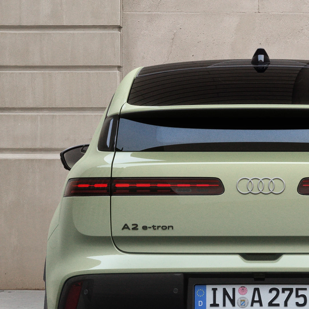 A square image of the from wheels of a blue Audi Q9.