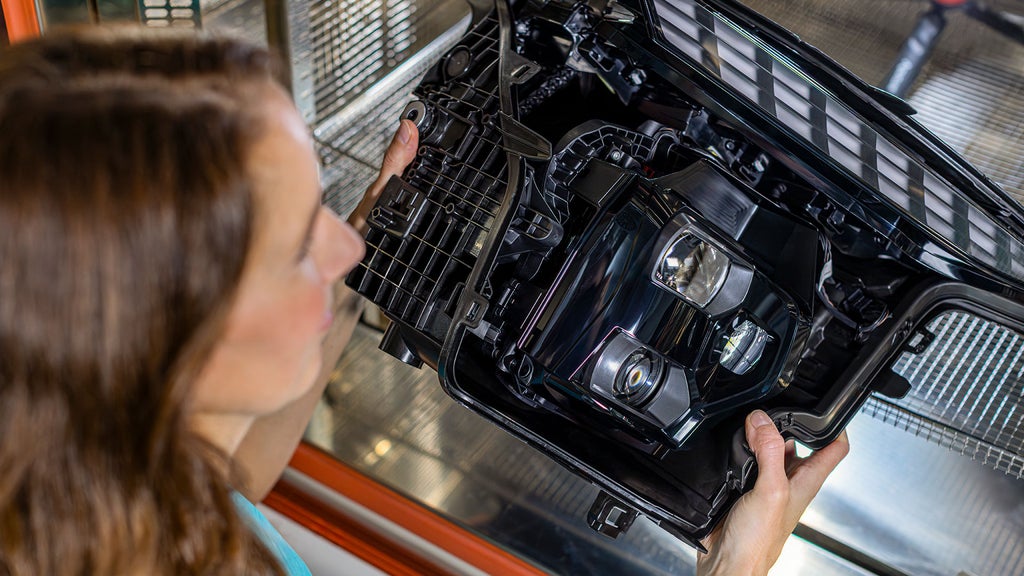 Meike is holding a headlight from an Audi vehicle