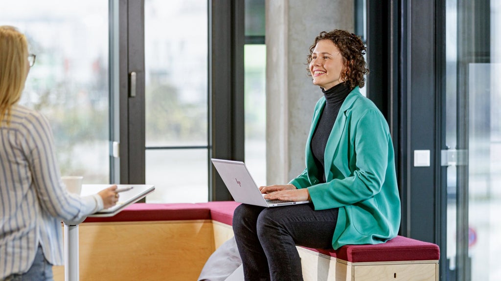 Sarah Schwellinger in conversation with colleagues