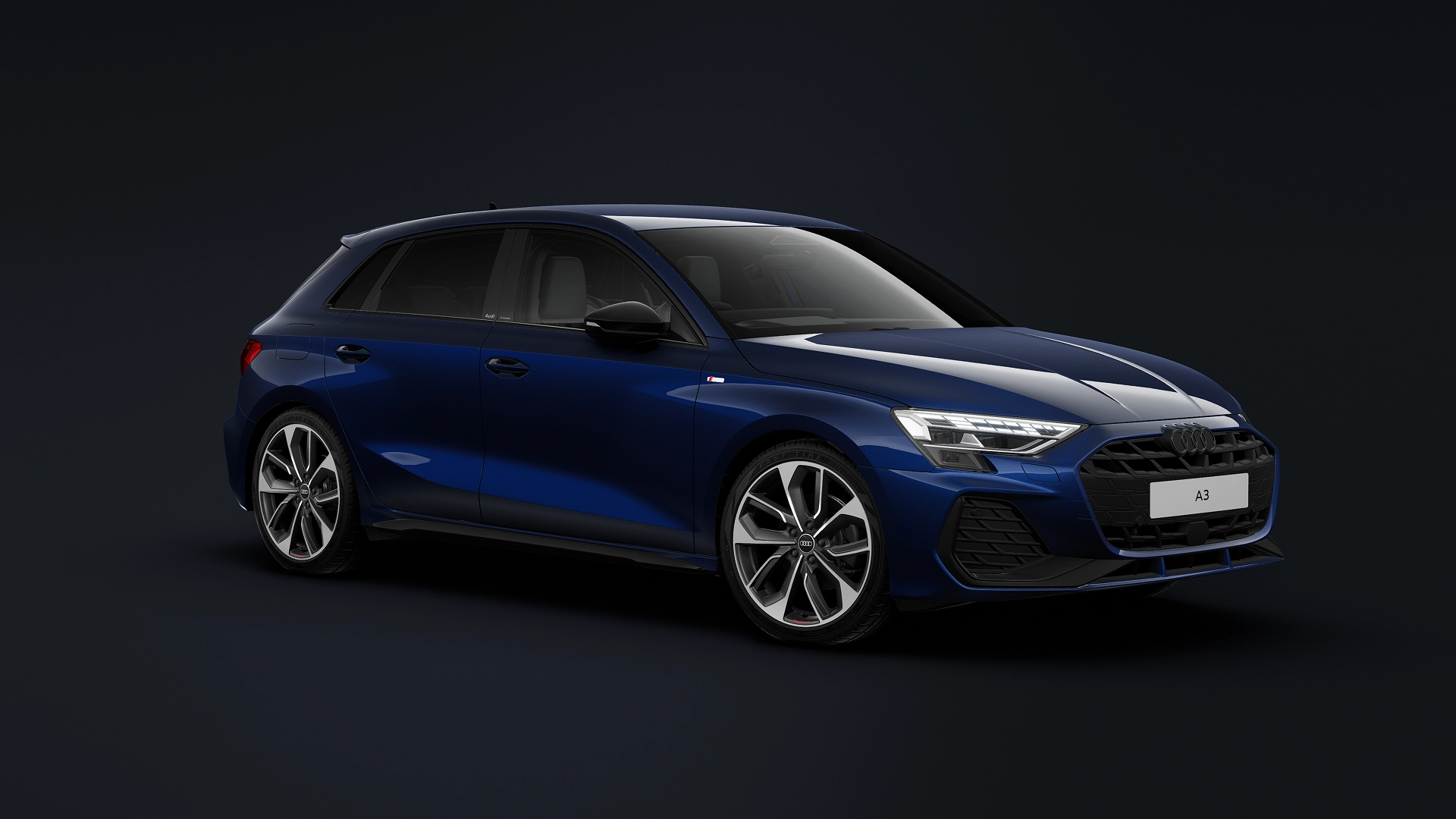 A sleek blue Audi A3 Sportback sedan is parked on a modern concrete surface in front of a minimalist building with dark glass panels. The vehicle features contemporary LED headlights, alloy wheels, and a sporty design with clean lines.