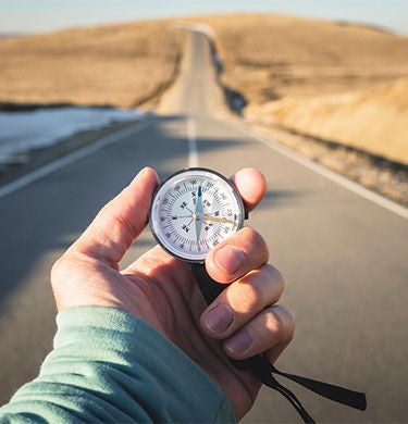 Person holding a compass