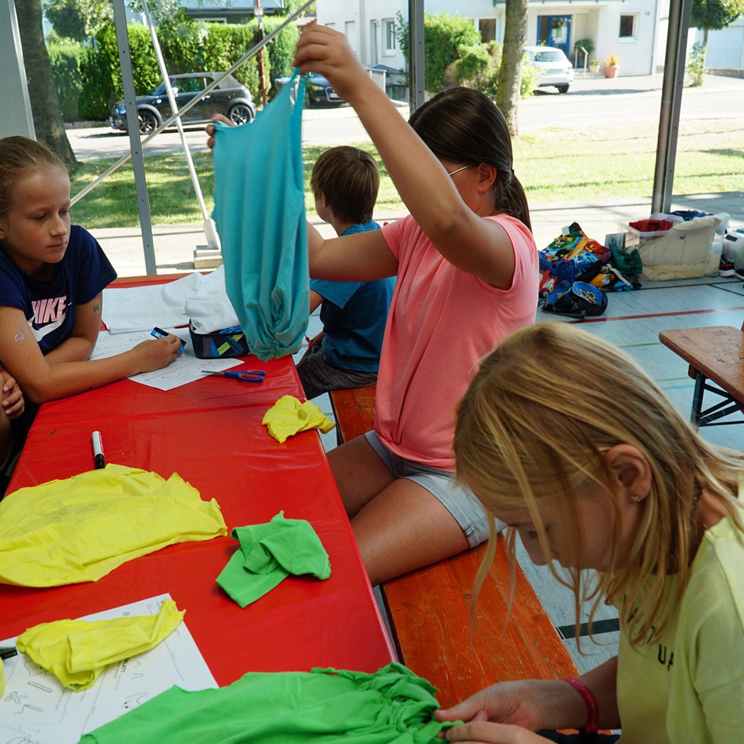 Young girls work with old T-shirts
