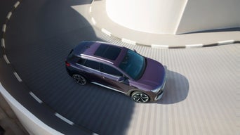 Areal shot of an Audi Q4 e-tron travelling down a spiral road