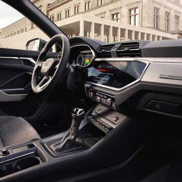 Inside view of Audi Q3 near classic building architecture.
