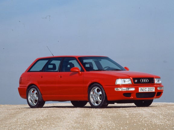 Right side view of a red Audi Avant RS 2 in front of a blue sky
