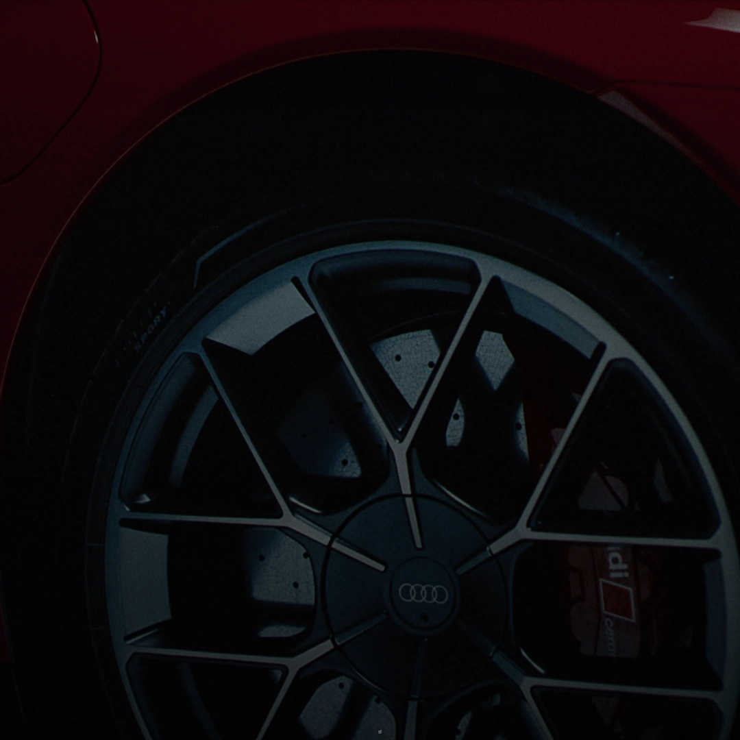 Close-up of a red Audi RS e-tron GT alloy wheel and red brake ceramic brake pads