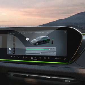 Close-up of the cockpit from the passenger's perspective, focusing on the MMI display. It shows the current charge level and a slider for adjusting the reserve.