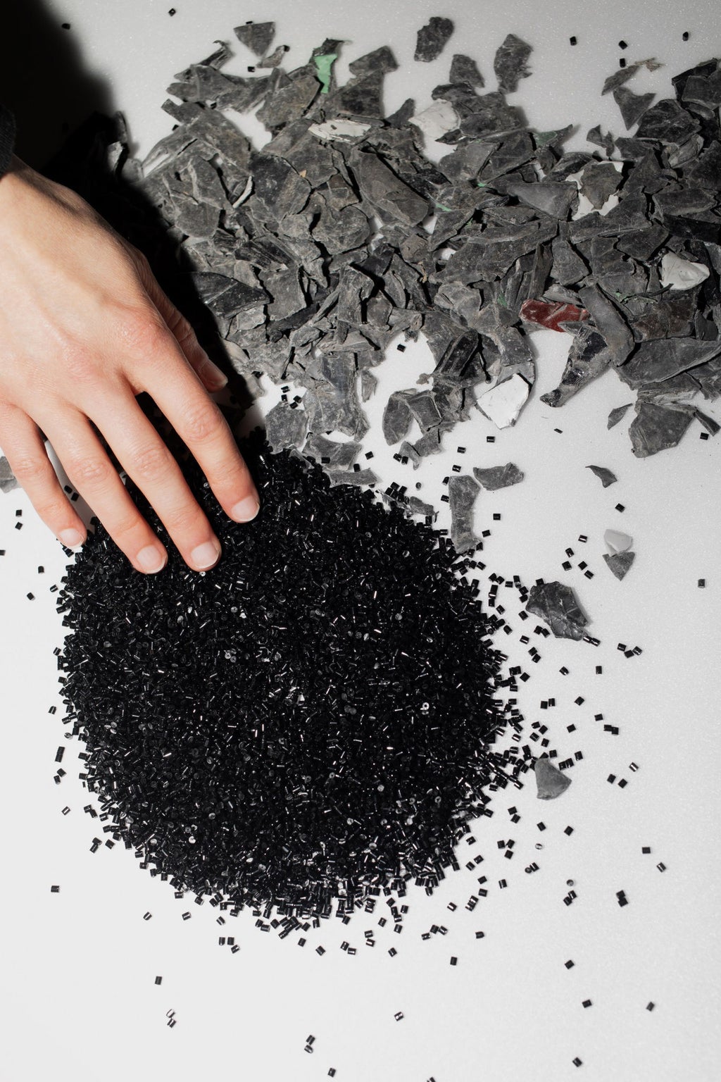 Plastic parts and plastic granules spread on a table.