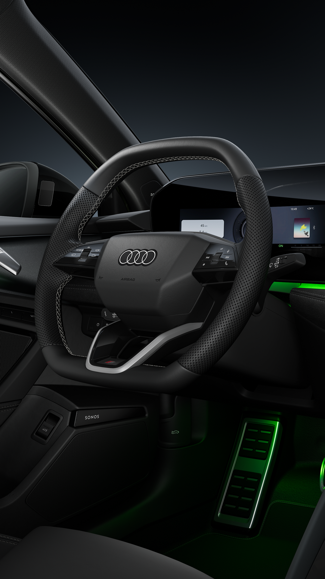 A view of the cockpit with its sports steering wheel, curved panoramic display and ambient lighting.