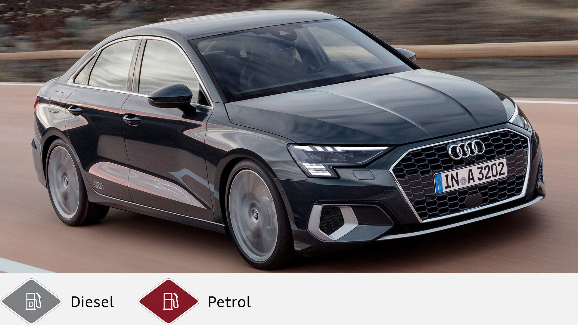 Dark gray Audi A3 sedan driving on a country road, taken diagonally from the front. Below, gray diesel symbol and red petrol symbol.