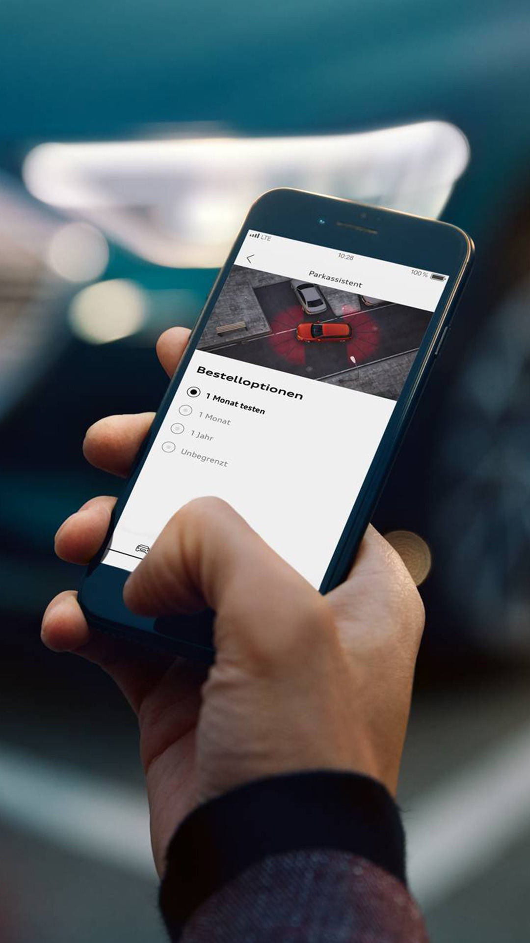 Phone in one hand with opened Audi Commerce Platform.