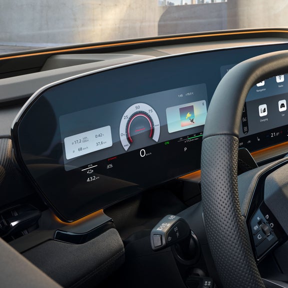 The cockpit and driver display as seen from the driver's window. The interaction light in sunny yellow can be seen below the windshield.