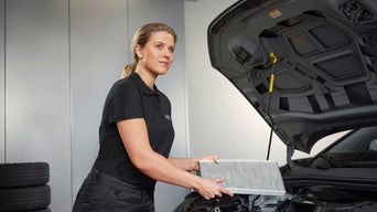 Audi service professional holding an interior air filter