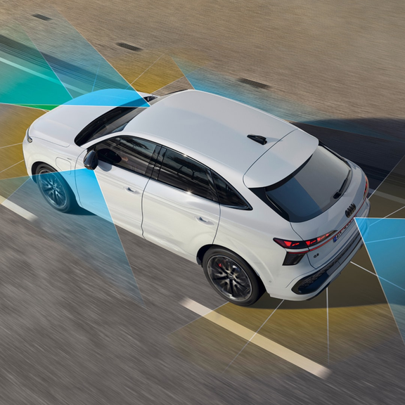 A person holding a smartphone with car control app before two parked Audi cars