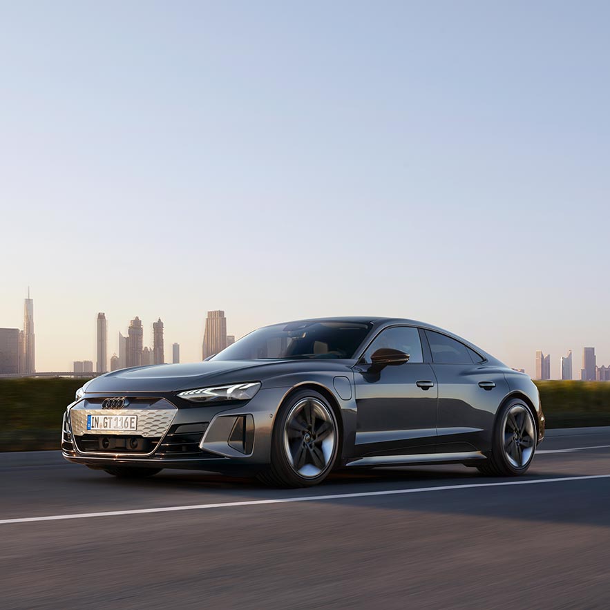 front side view of Audi RS e-tron GT with city skyline in the background