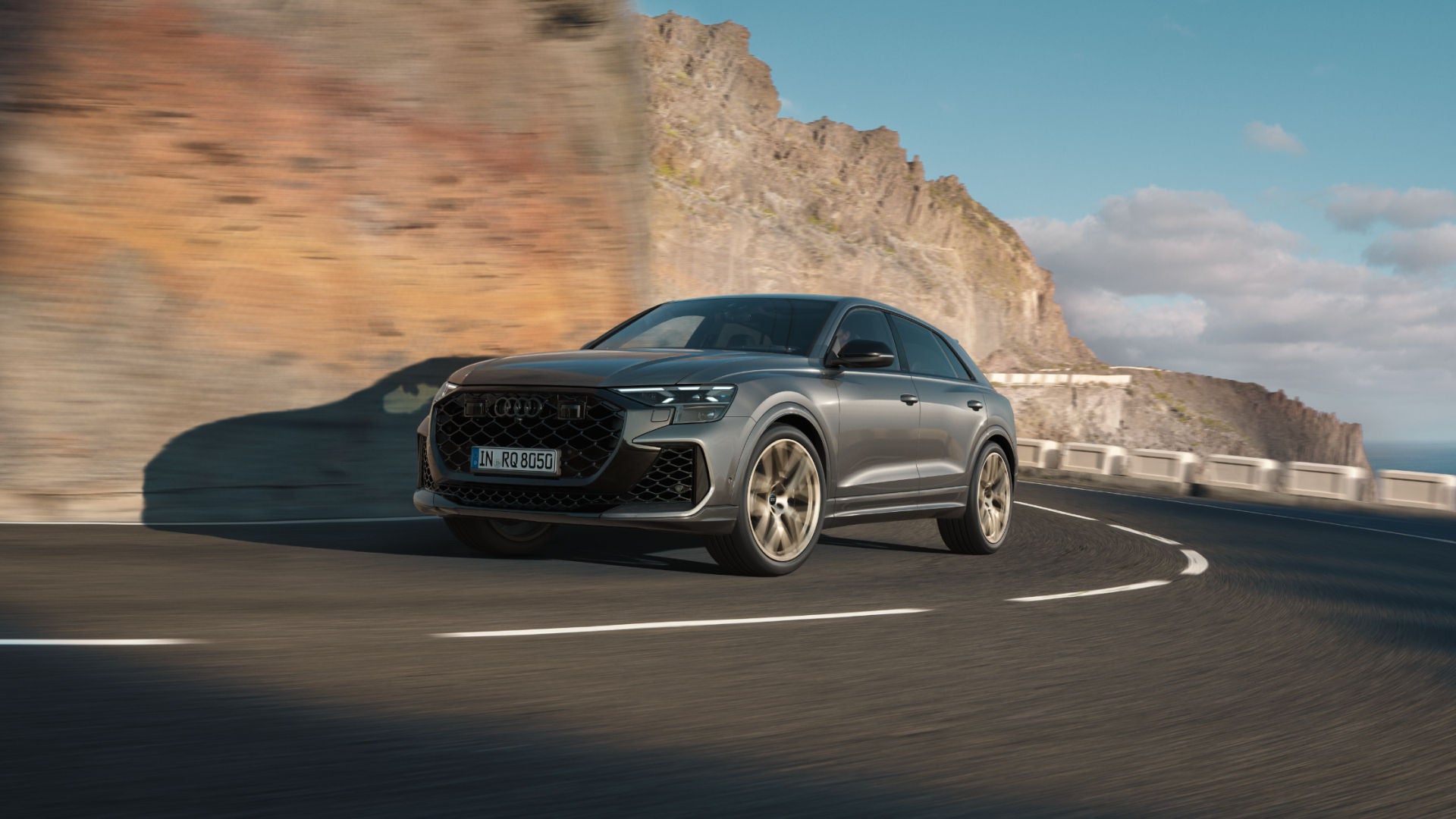 An Audi SUV in motion on a rocky mountain road