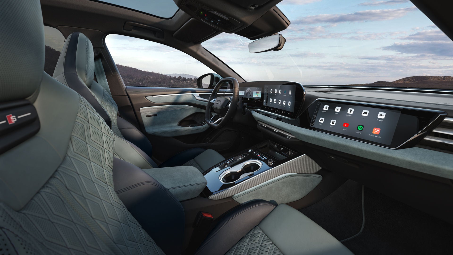 View through the passenger-side window into the cockpit of the A6 Avant e-hybrid. The interior features mint-grey upholstery.