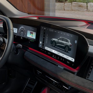 The cockpit and panoramic display as seen from the passenger's perspective. The interior is illuminated by red ambient lighting.