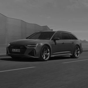 A grey image of an Audi RS 6 Avant performance in motion on the road
