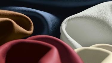 Abstract view of variously coloured soft fabric folds with a focus on texture.