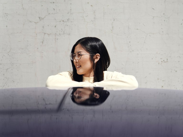 Tiantian leans on a purple Audi