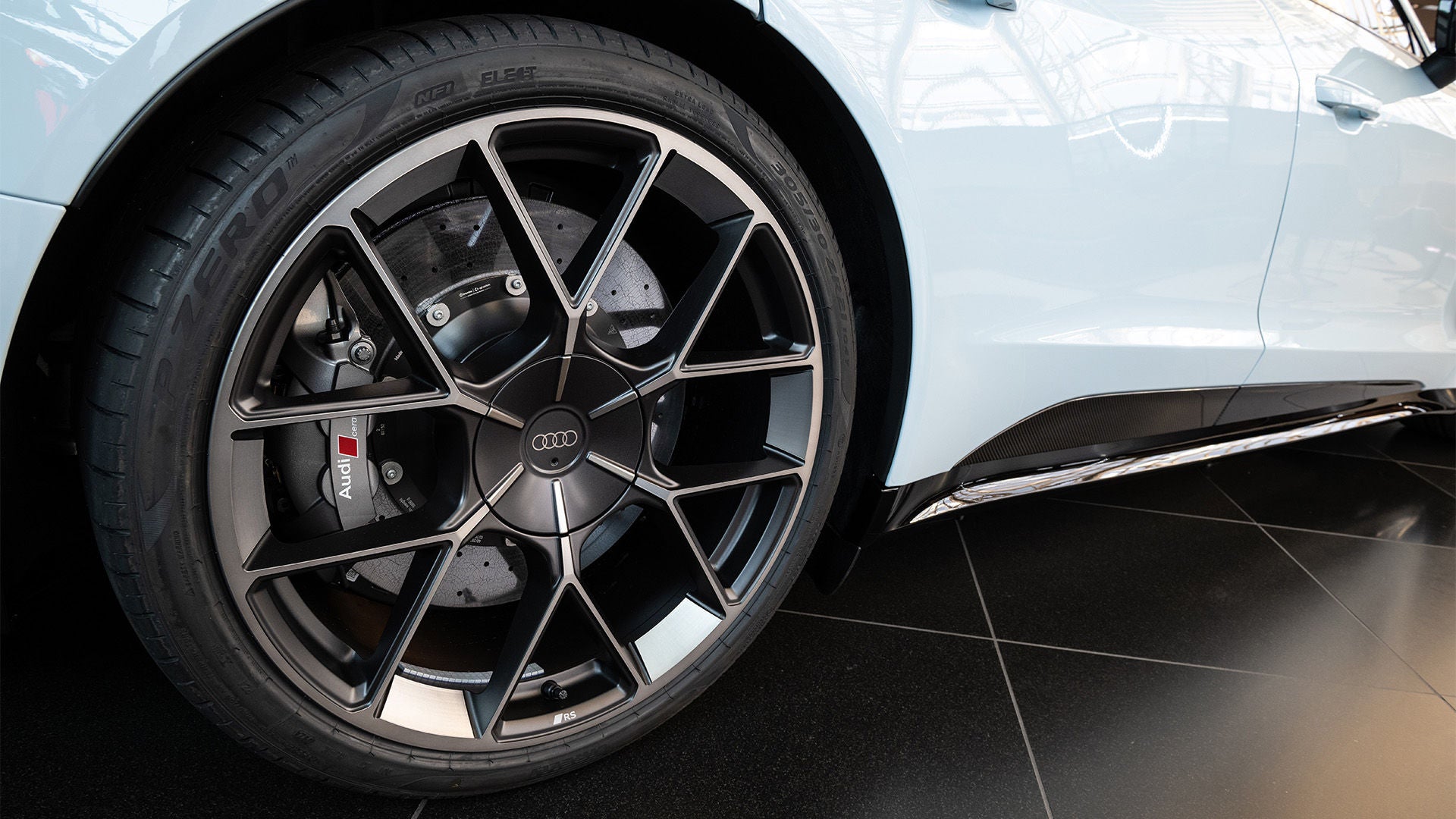 Close-up of an Audi wheel with rim and red brake caliper.