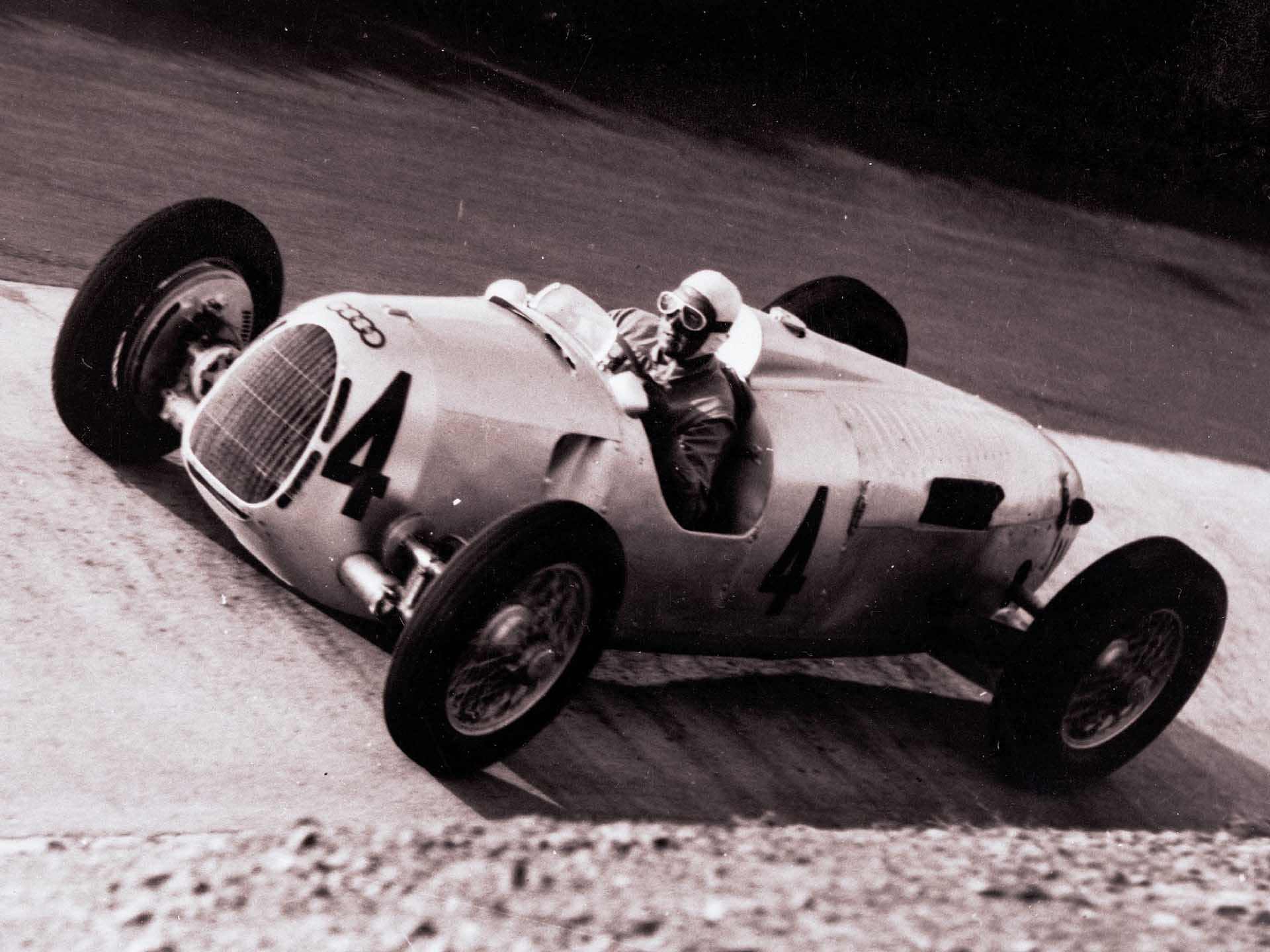 A picture showing an Auto Union Type C Grand Prix race car on track at the Nürburgring.